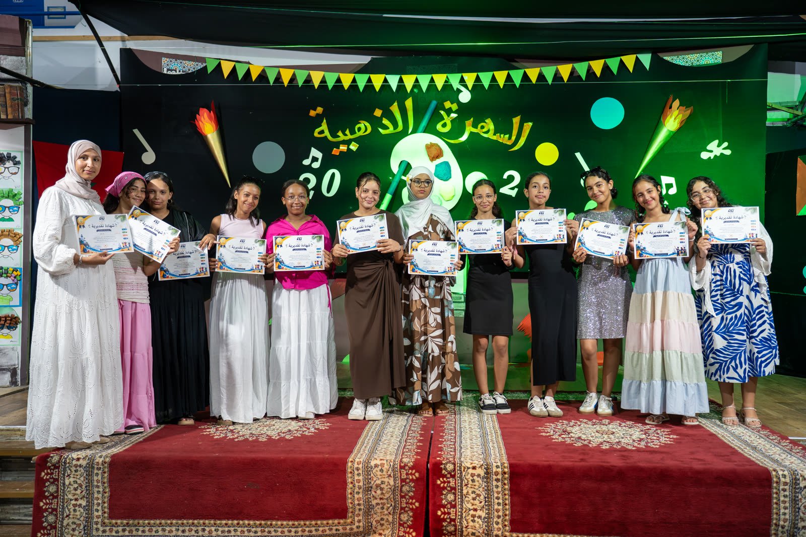 Girls receiving certificates on closing night
