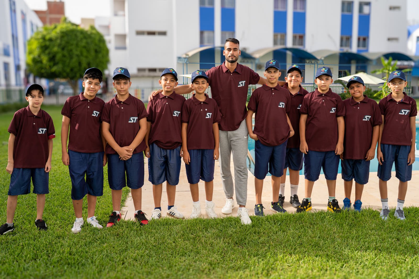 Boys' team in camp colours by the pool